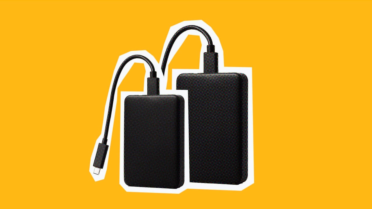 image of two hard drives on an orange background for digital asset management workflow