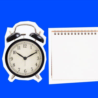 alarm clock and notebook on blue background for meeting deadlines