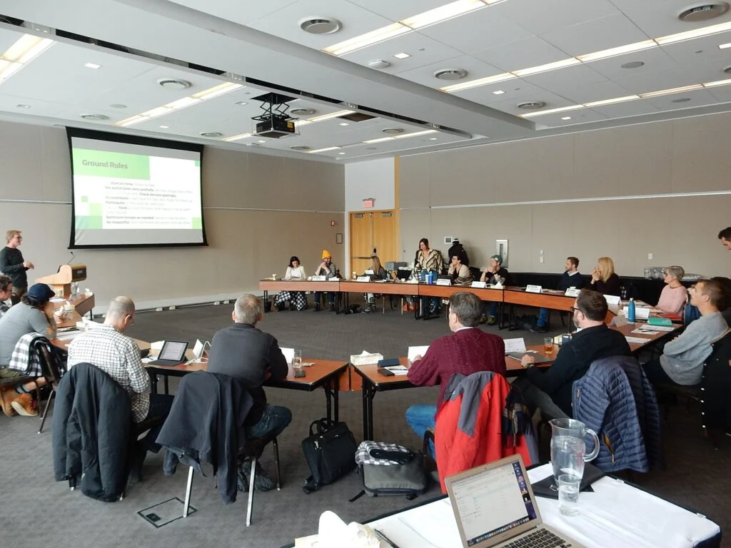 Participants working at Owner Camp conference