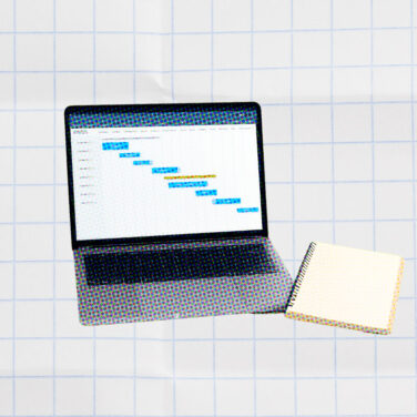 laptop with a gantt chart on it on a white background for project management principles