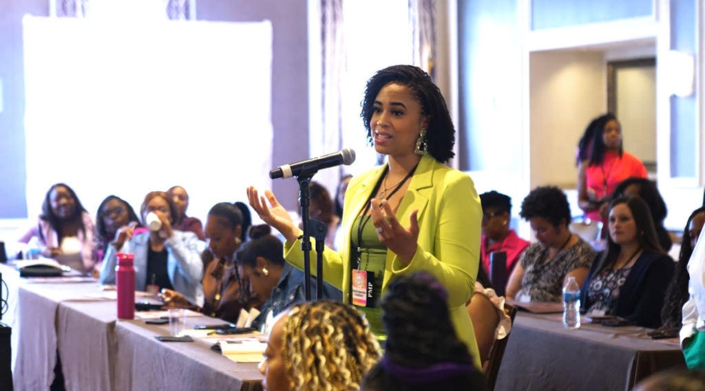 Attendee raising question at the Women of Project Management Conference 2025