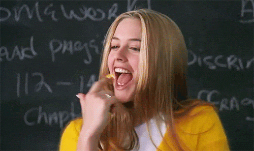 GIF from Clueless of a student stretching gum with her finger to show pride